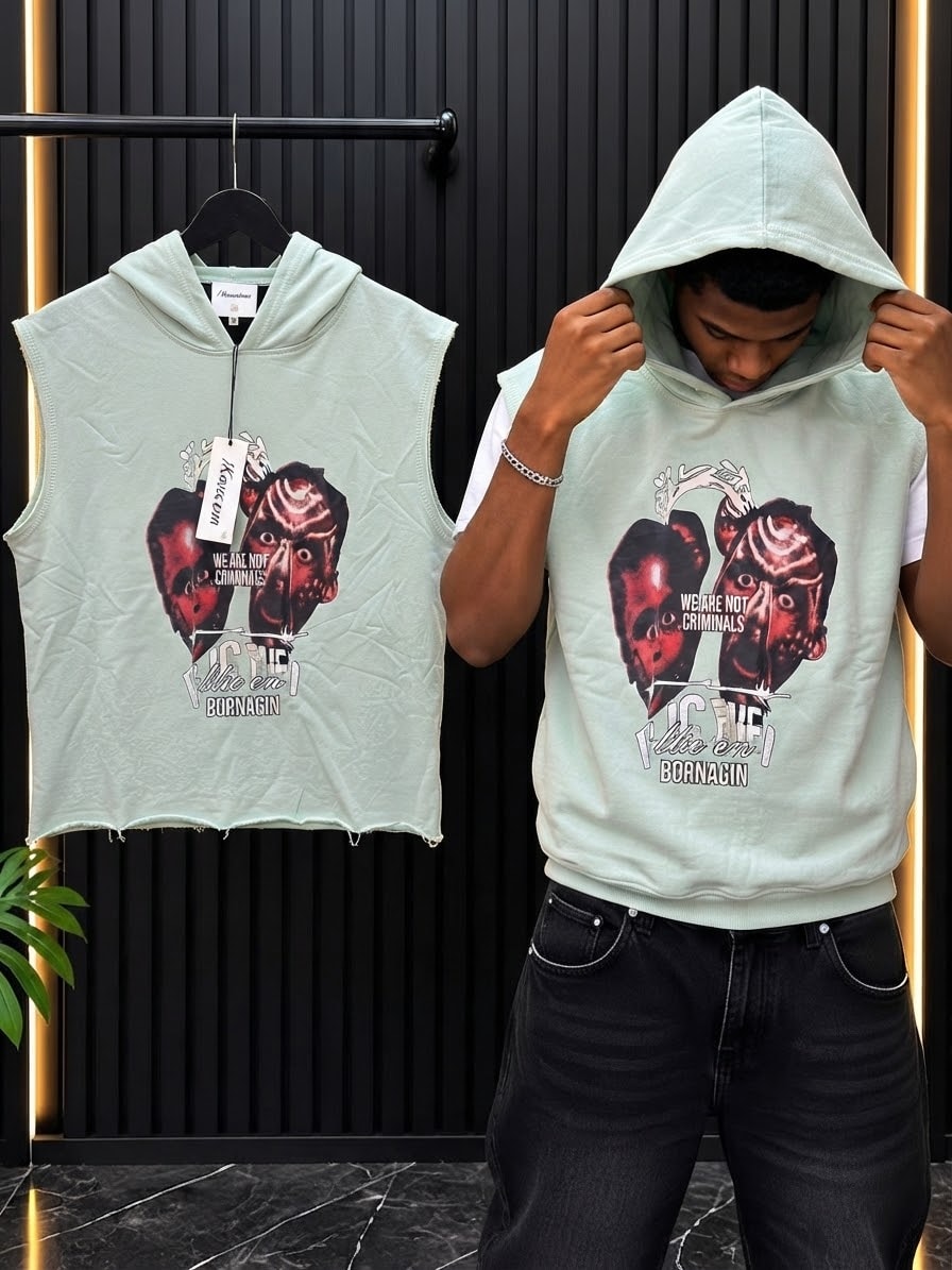 Light green cropped armless hoodie with face graphics and text shown on model and hanger.