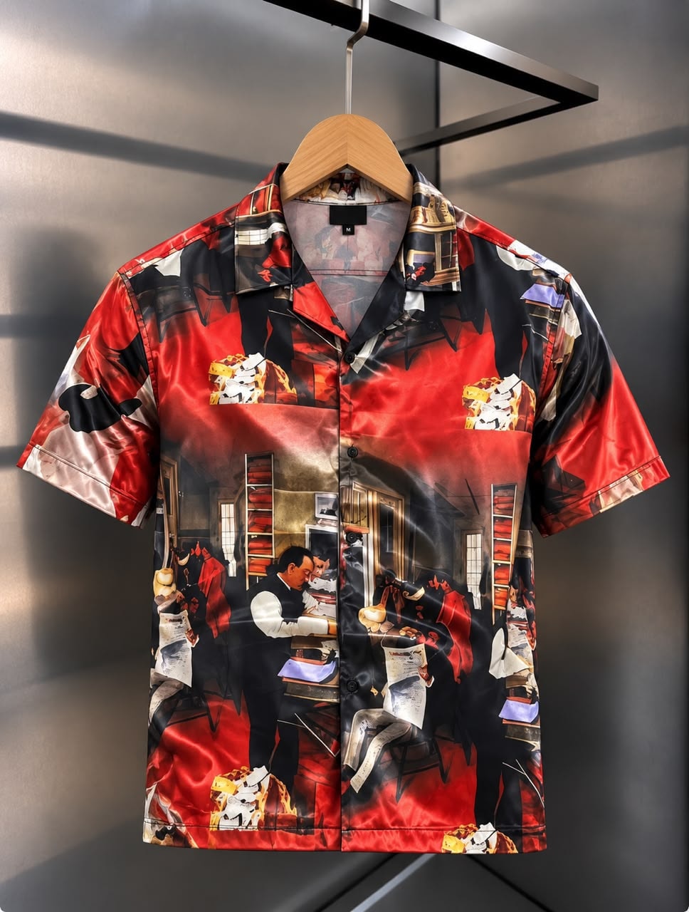 Front view of short-sleeved satin shirt with beige and black fishing scene print featuring fish and landscape elements.