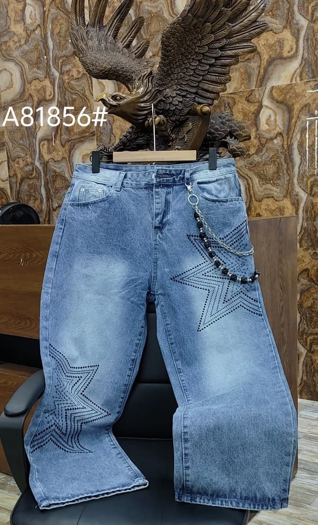 Light blue baggy jeans with black star patterns on legs and black beaded chain.