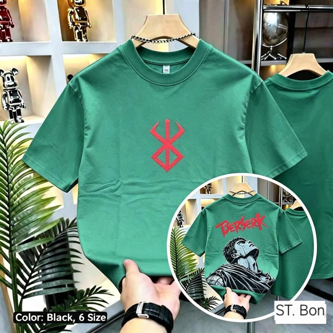 Green Berserk t-shirt on hanger showing front symbol with inset displaying back BERSERK print.