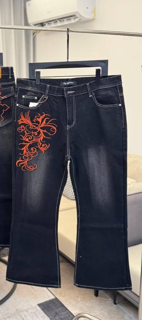 Purple black flare jeans with gold swirl embroidery on lower legs and lace-up front, front and back views.