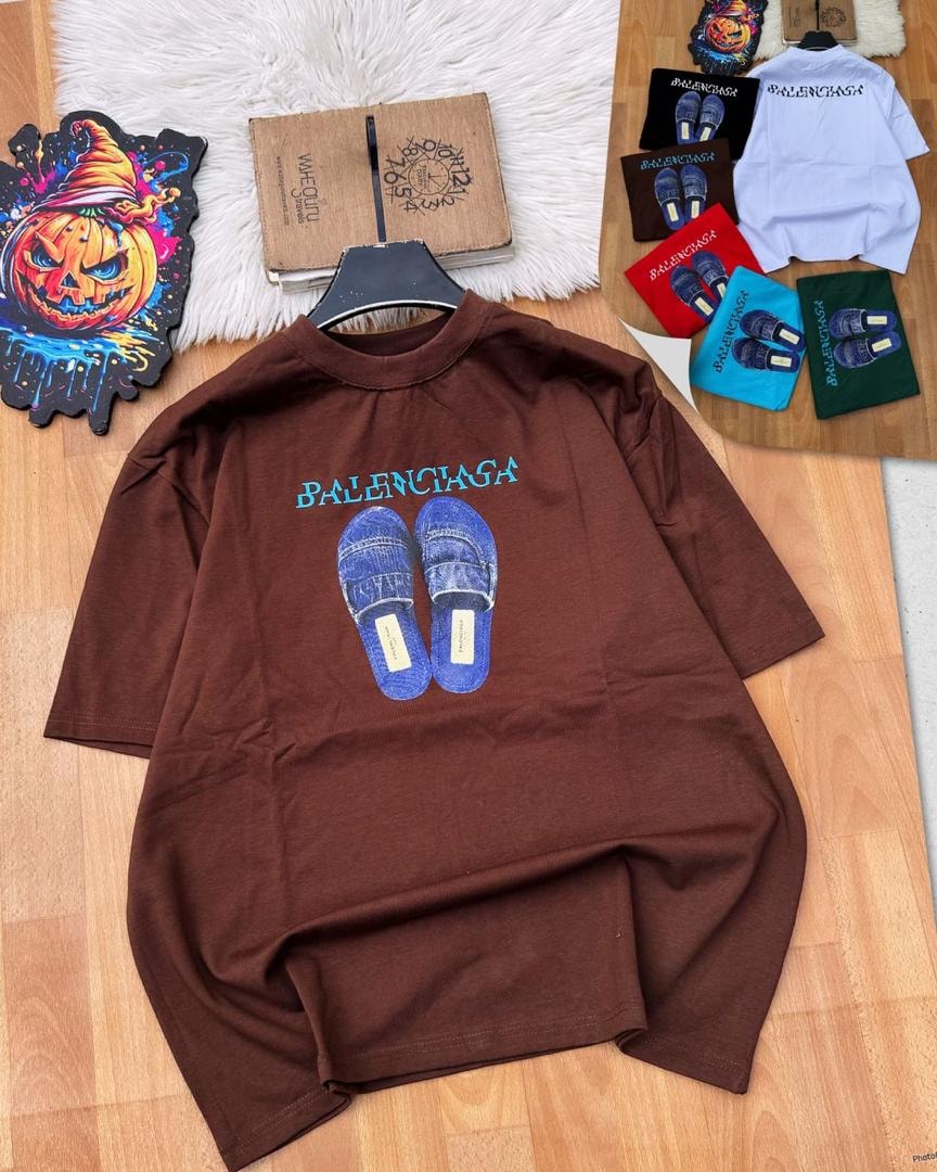 Brown Balenciaga slipper graphic t-shirt on wooden floor.