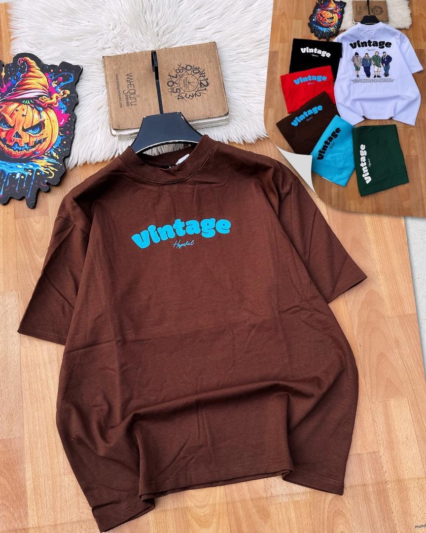 Brown Vintage Hopeful logo t-shirt on wooden surface.