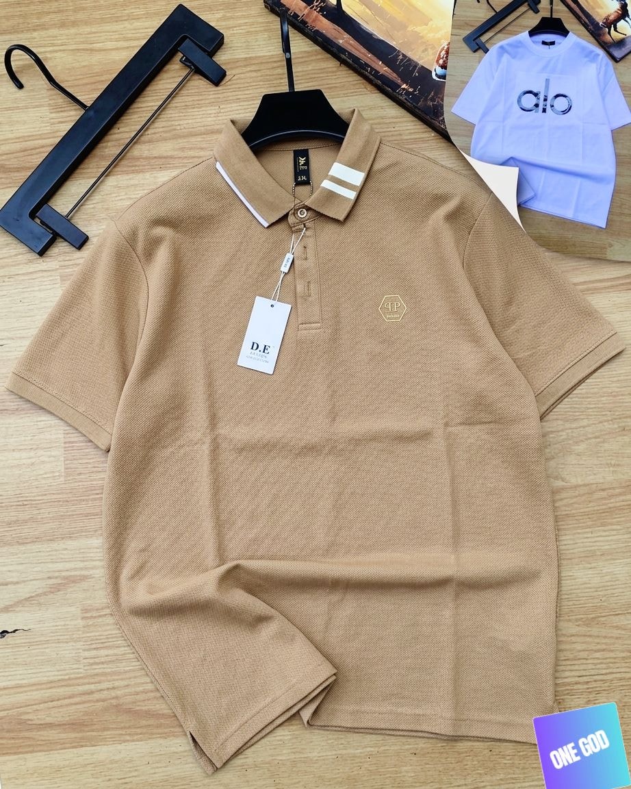 Tan luxury polo shirt with white striped collar and hexagon chest logo.