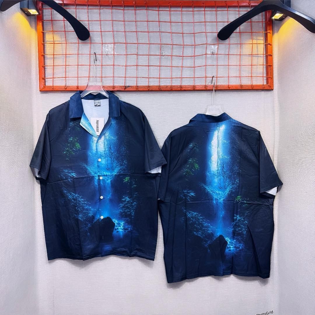 Front and back views of blue waterfall print short sleeve shirt hanging against white wall.