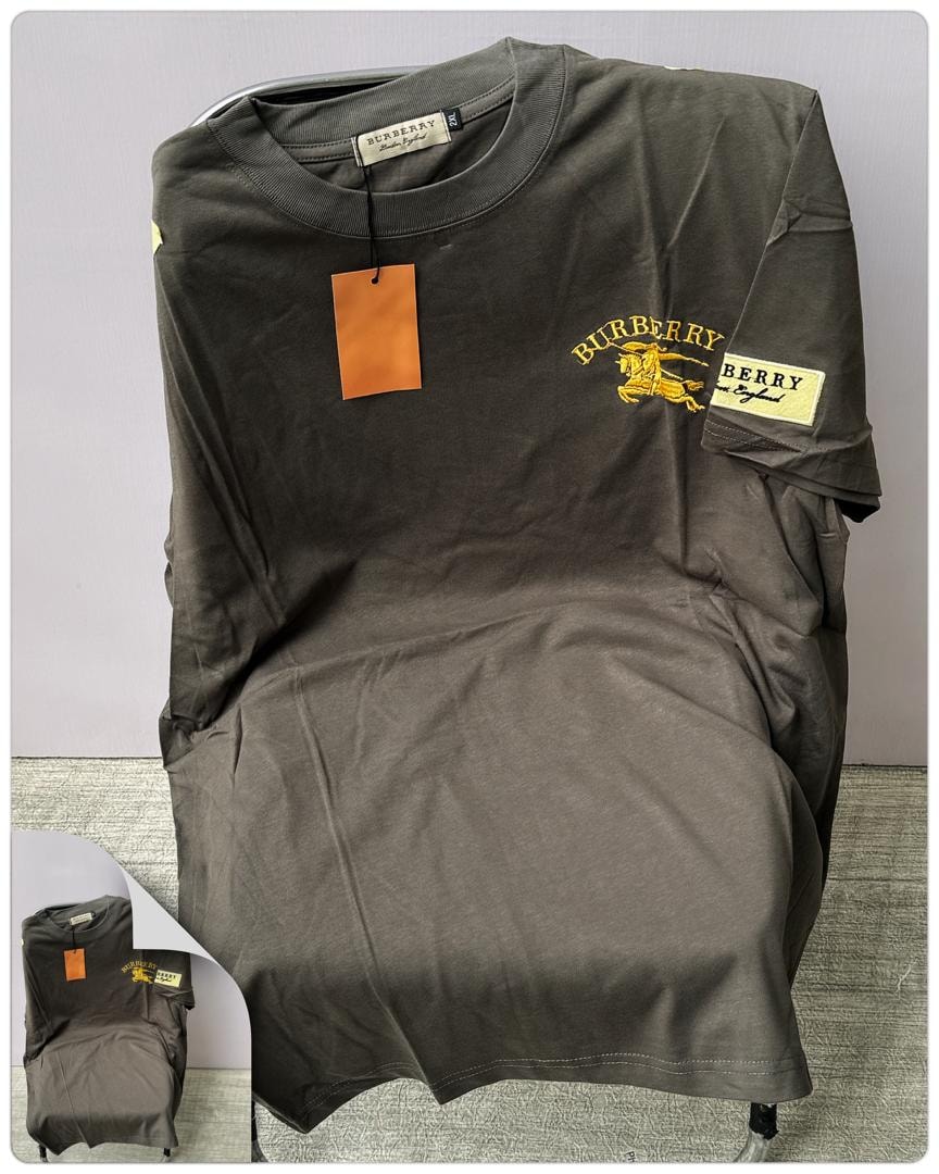 Dark olive round neck t-shirt with yellow Burberry embroidery and sleeve patch.