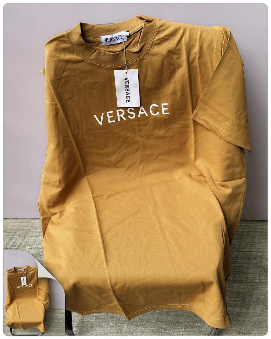 Tan round neck t-shirt with white VERSACE text print on chest.
