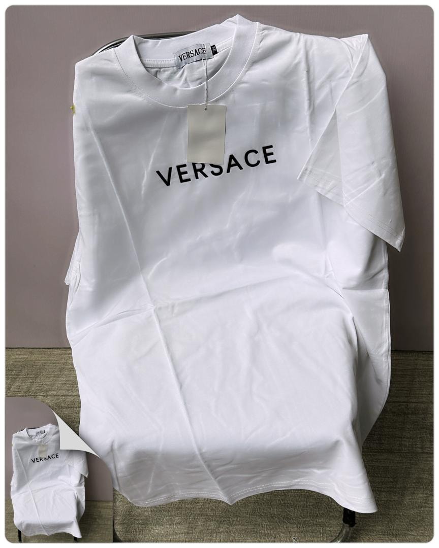 White round neck t-shirt with black VERSACE text print on chest.