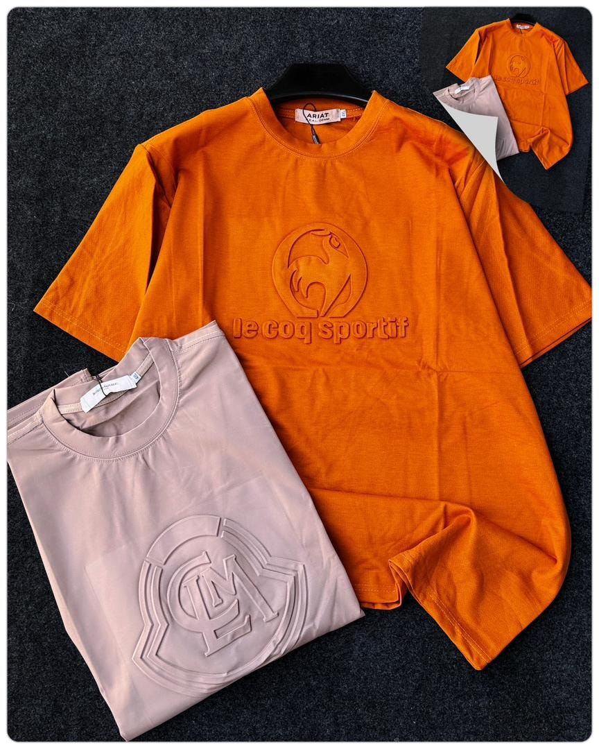 Orange Le Coq Sportif round neck t-shirt with embossed rooster logo.