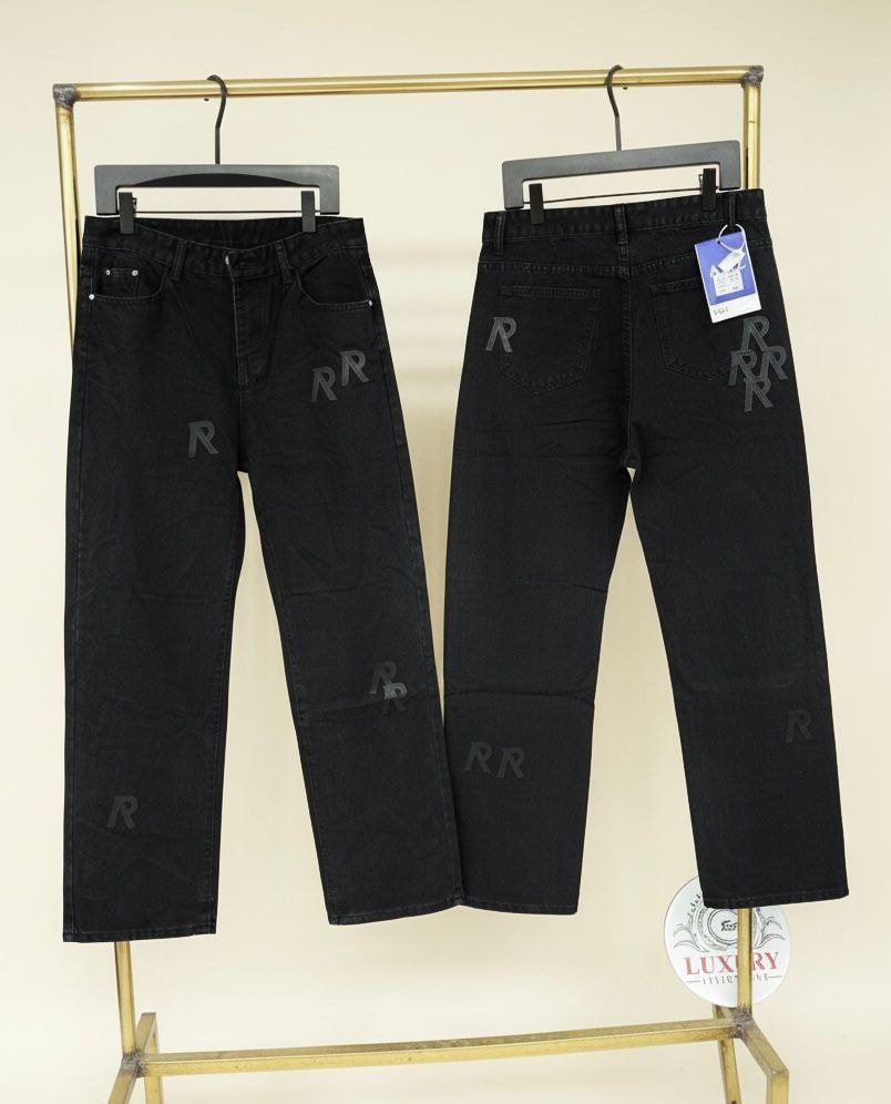 Black baggy jeans with all-over repeating RR monogram print, front and back views.