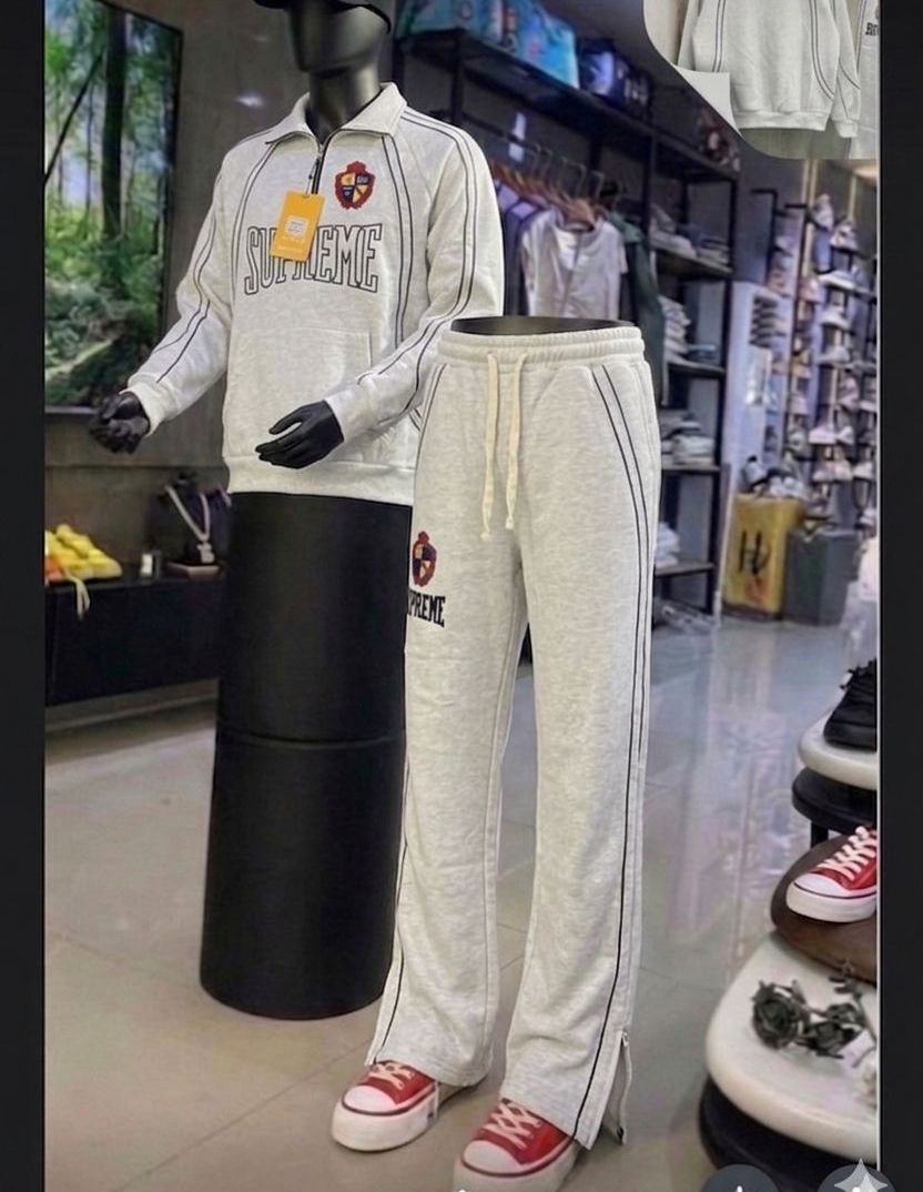 Gray Supreme tracksuit set on mannequin with flat lay details.