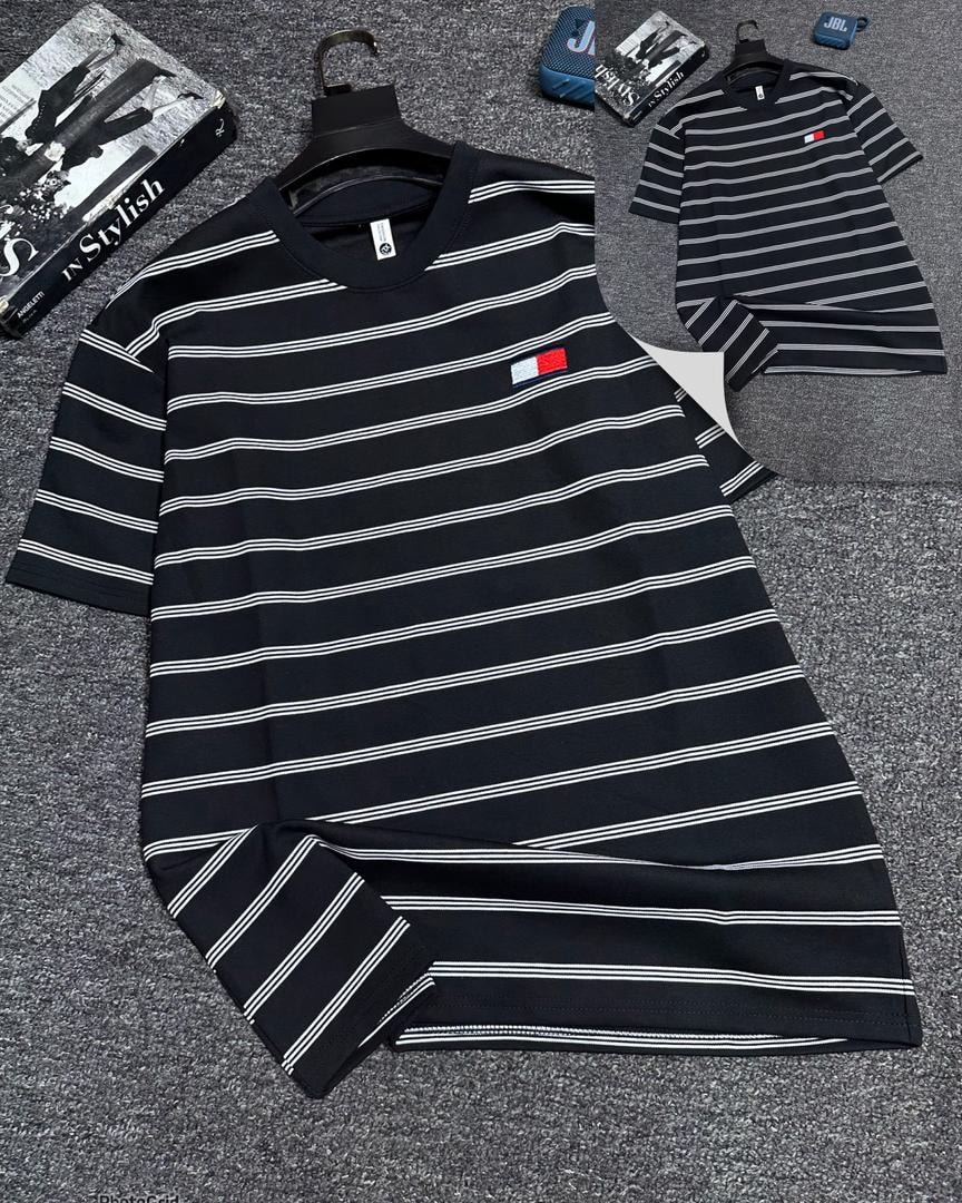 Black and white striped oversized t-shirt with small chest logo.