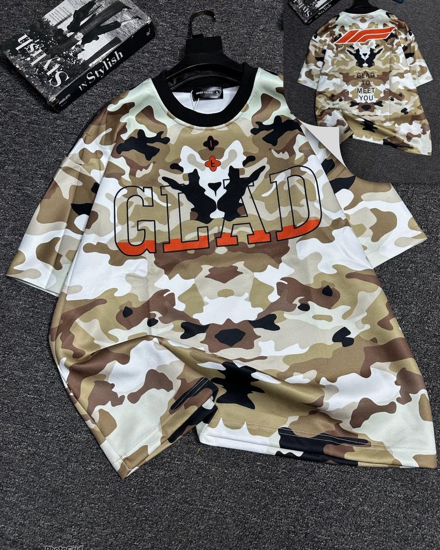Oversized t-shirt in brown camouflage with large GLAD graphic print on front.