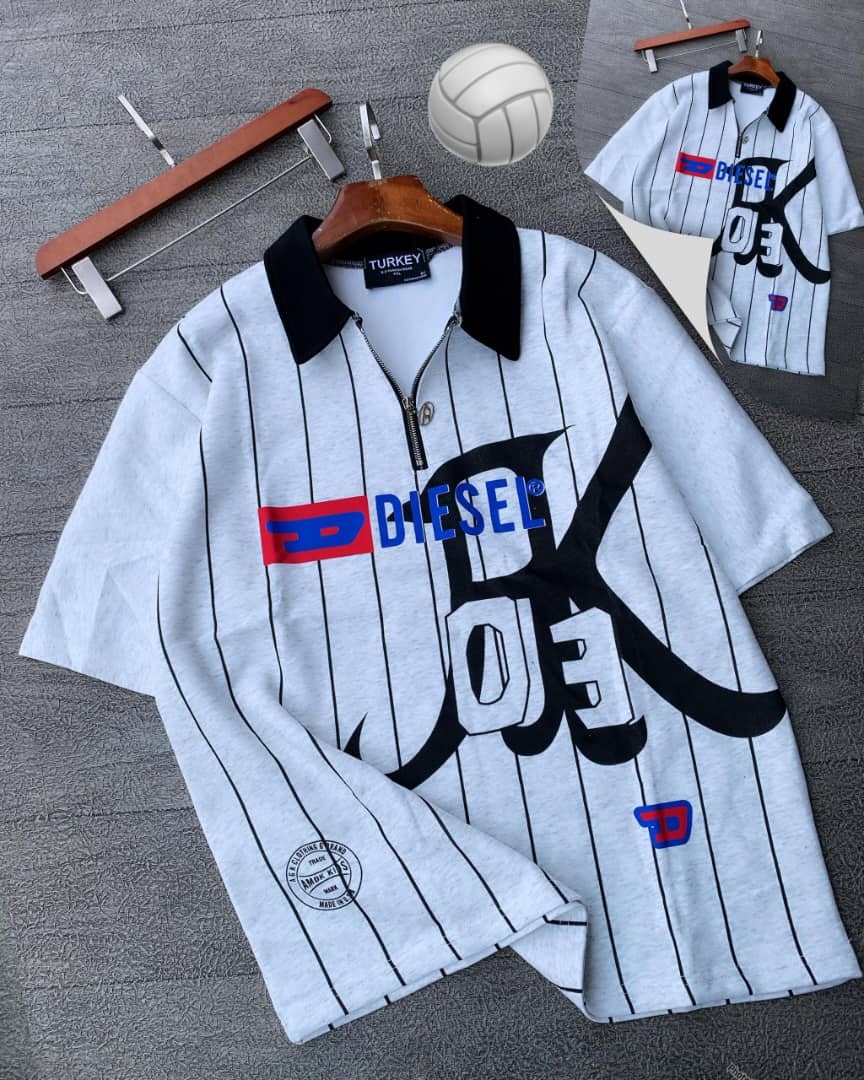 Gray striped Diesel graphic polo shirt on hanger with props.