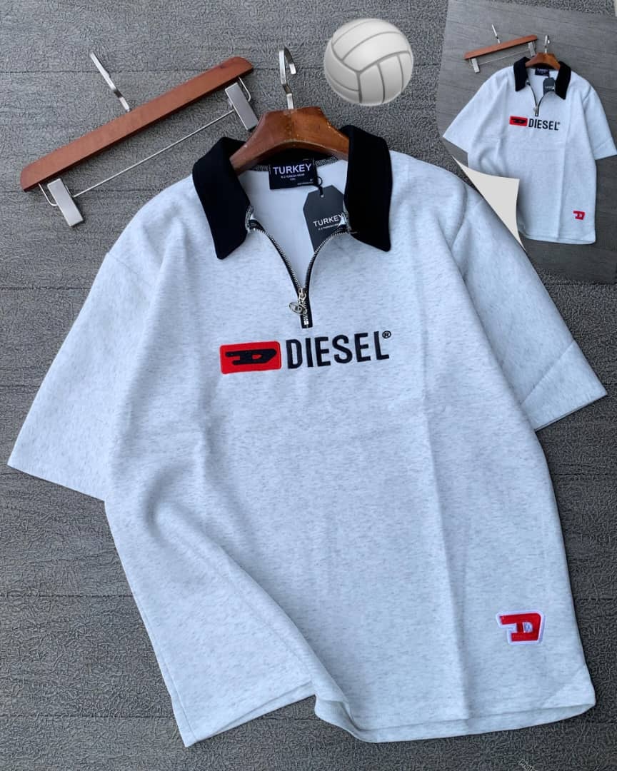 Gray Diesel quarter-zip polo shirt on wooden hanger with props.
