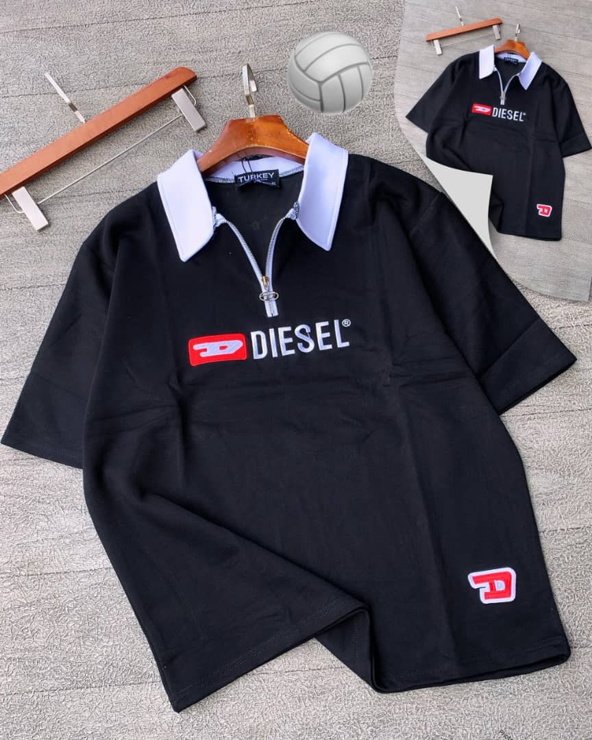 Black Diesel quarter-zip polo shirt on wooden hanger with props.