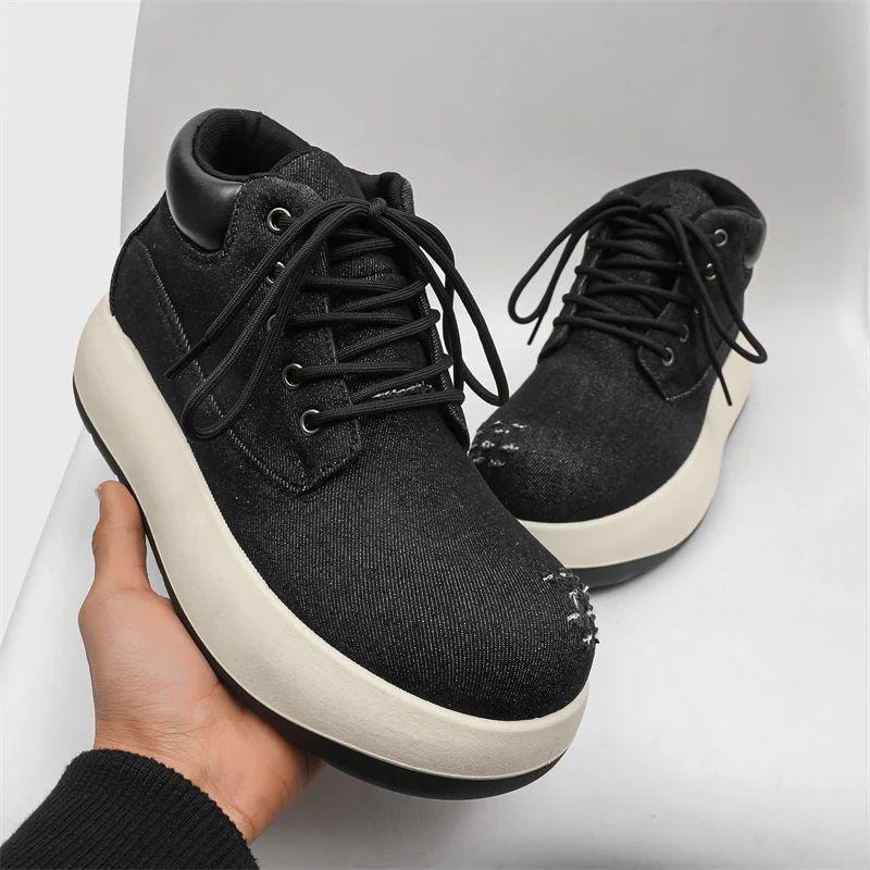 Black denim chunky platform sneakers displayed on white background with one held in hand.