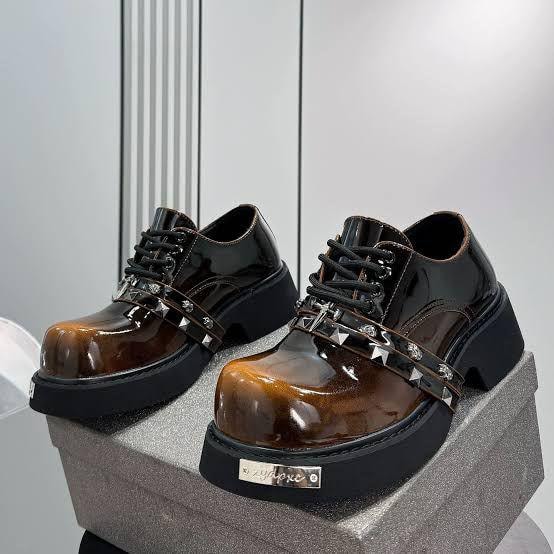Chunky platform studded lace-up shoes in glossy brown and black patent leather with metal accents