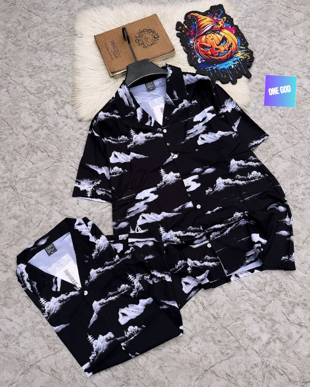 Black shirt and shorts with white landscape print.