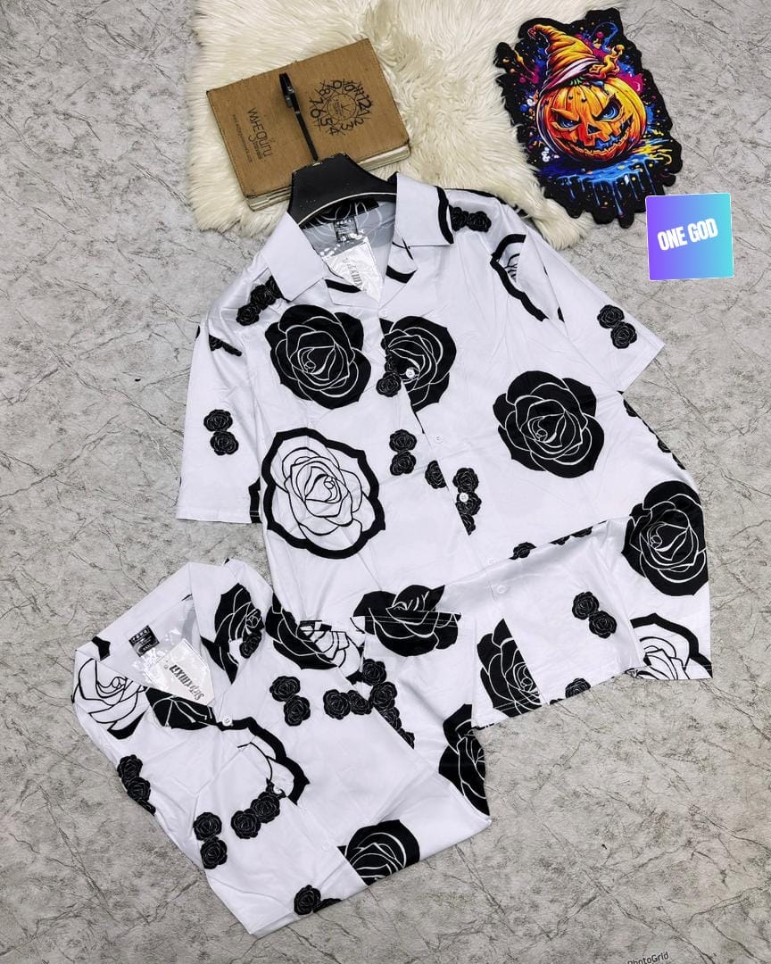 White short sleeve shirt and shorts with large black rose prints.