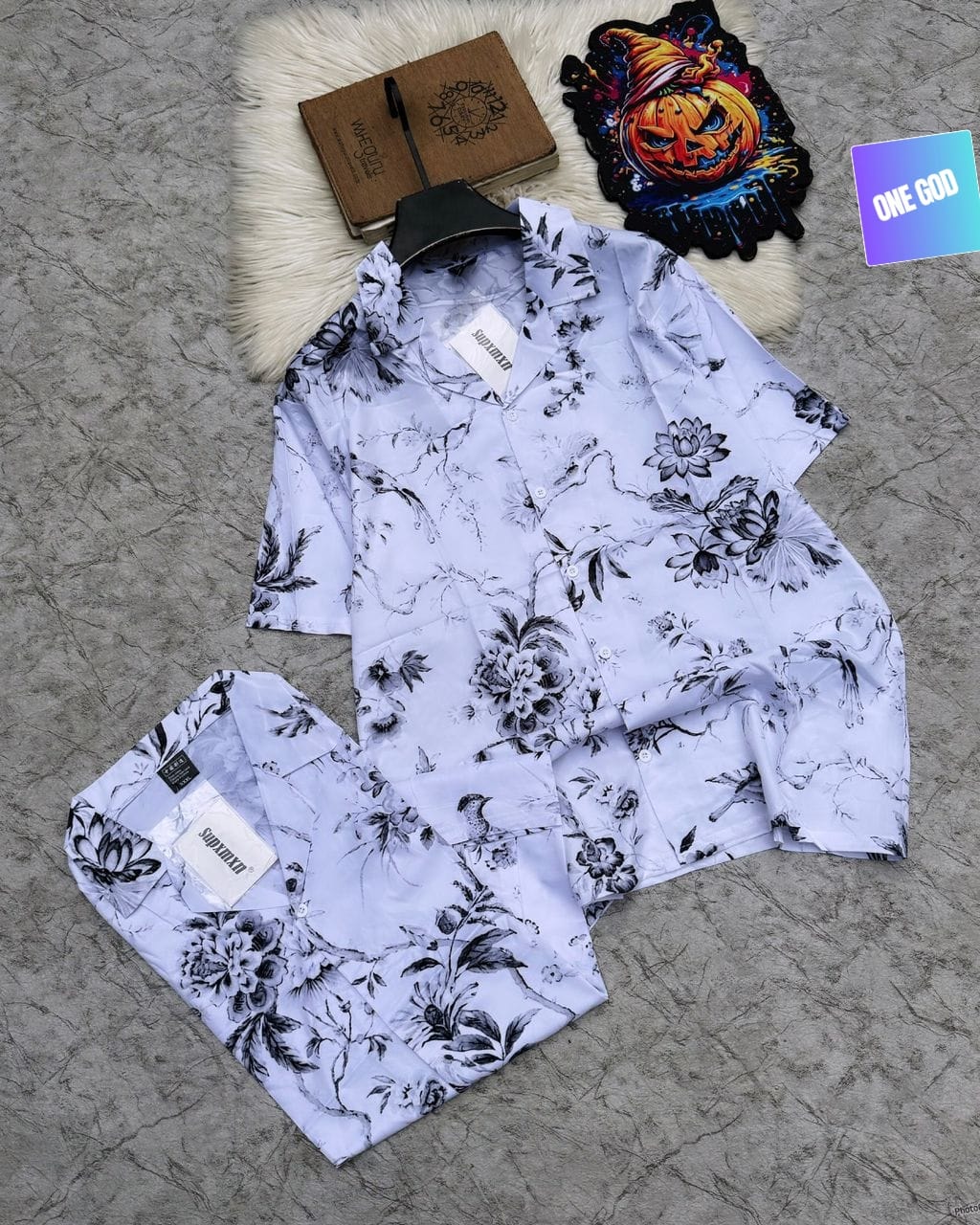Light purple short sleeve shirt and shorts with black and white floral and butterfly prints.