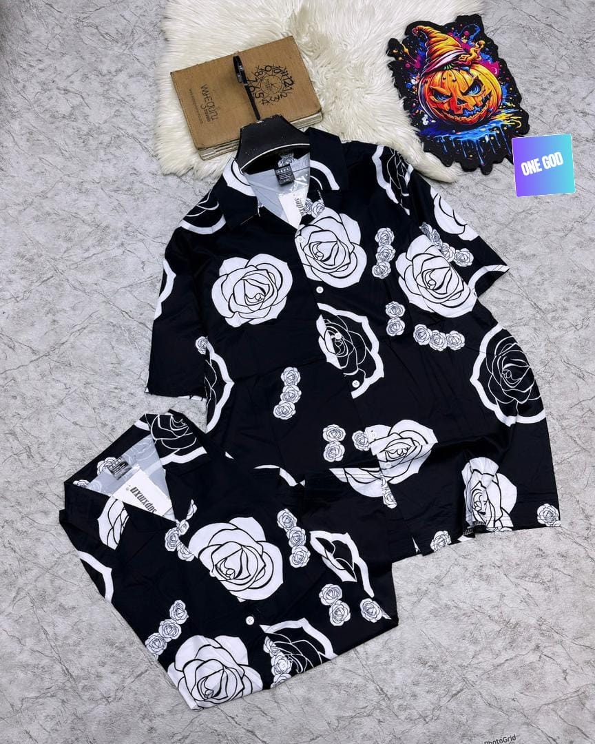 Black short sleeve shirt and shorts with white rose floral outline print.