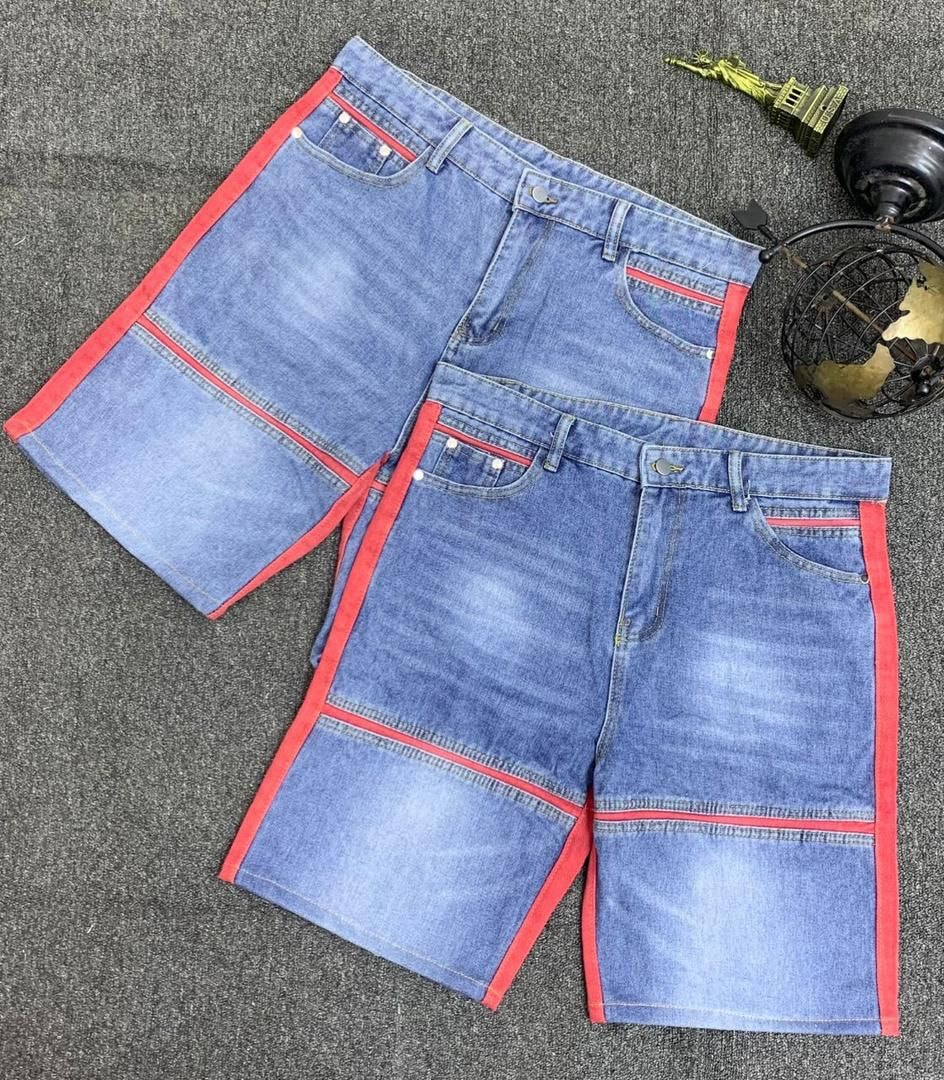 Two pairs of blue denim shorts with red contrast stripes on sides and pockets.