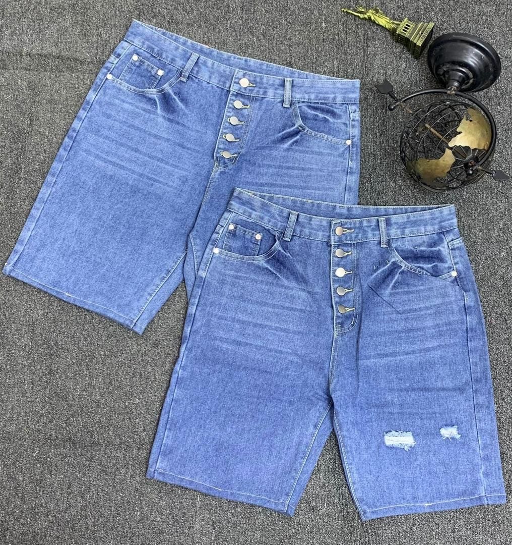 Two pairs of light blue denim shorts with button fly closures, one with small rips.