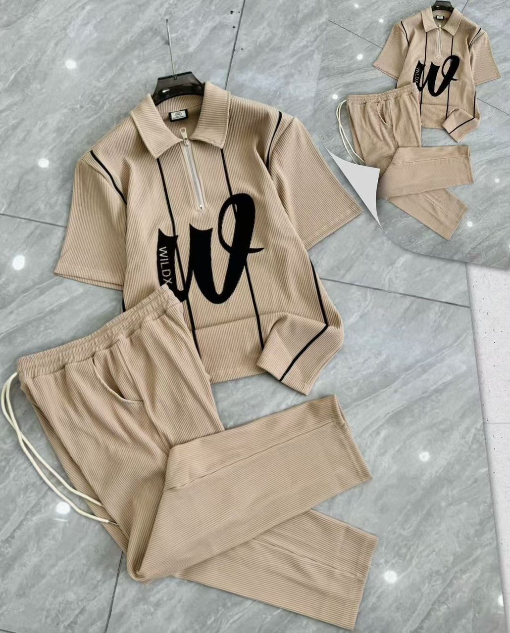 Beige ribbed two-piece set with zip polo shirt and matching pants.