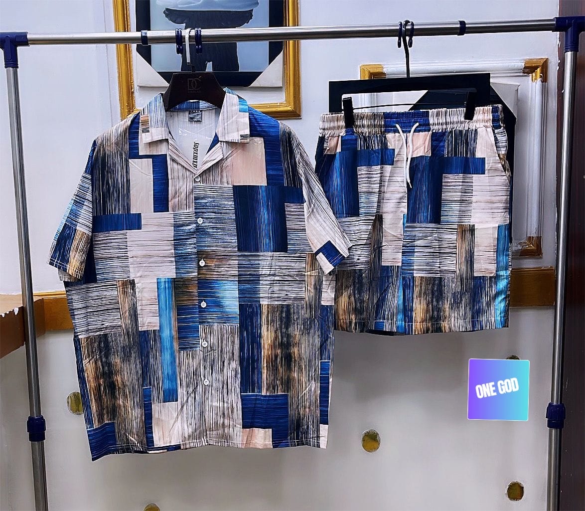 Multi-colored abstract patchwork two-piece shirt and shorts set in blue, beige and brown tones.