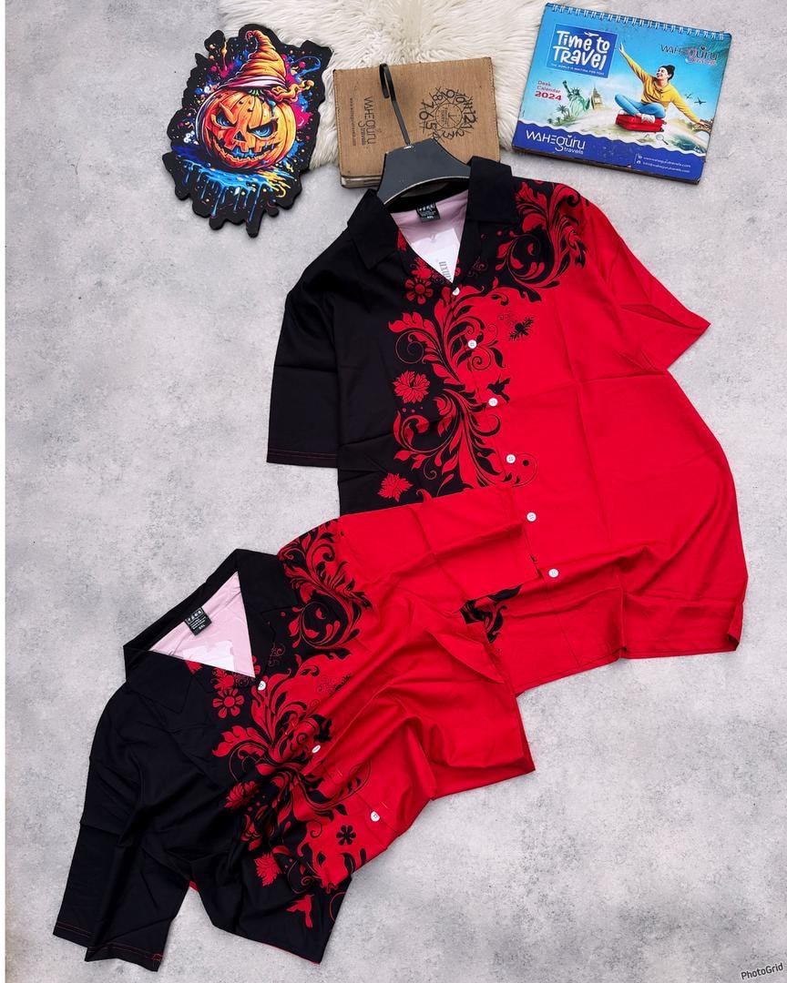 Red and black floral print shirt and shorts set arranged on gray background.