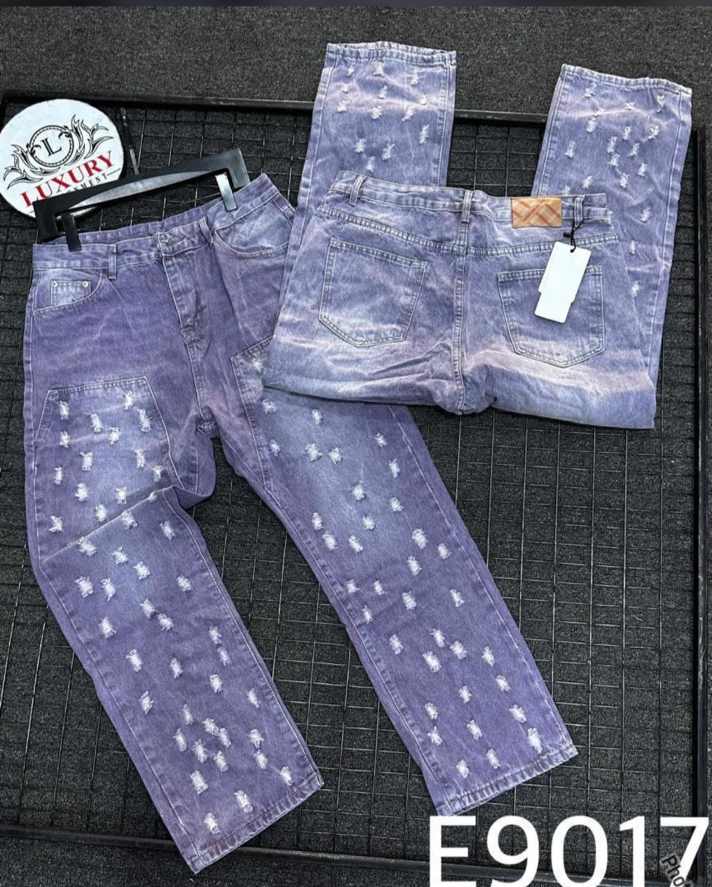 Purple distressed baggy jeans displayed from front, back and side angles showing all-over white speckled pattern.