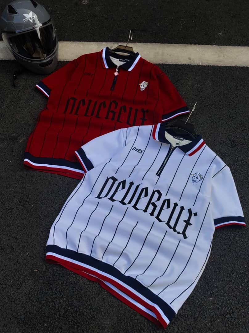 Red and white striped polo shirts with gothic text, skull logos, and striped trims beside a helmet.