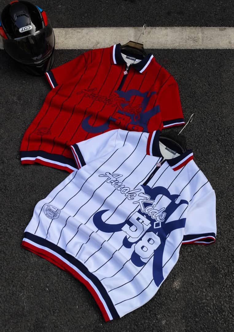 Red and white striped polo shirts with Amok Kids 58 script, blue graphics, and contrasting trims.