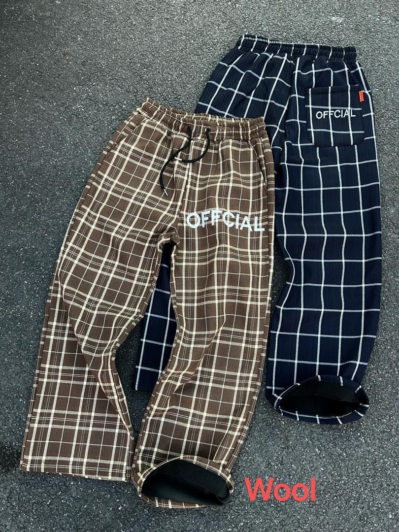 Brown and navy plaid Official joggers on concrete showing interior lining.