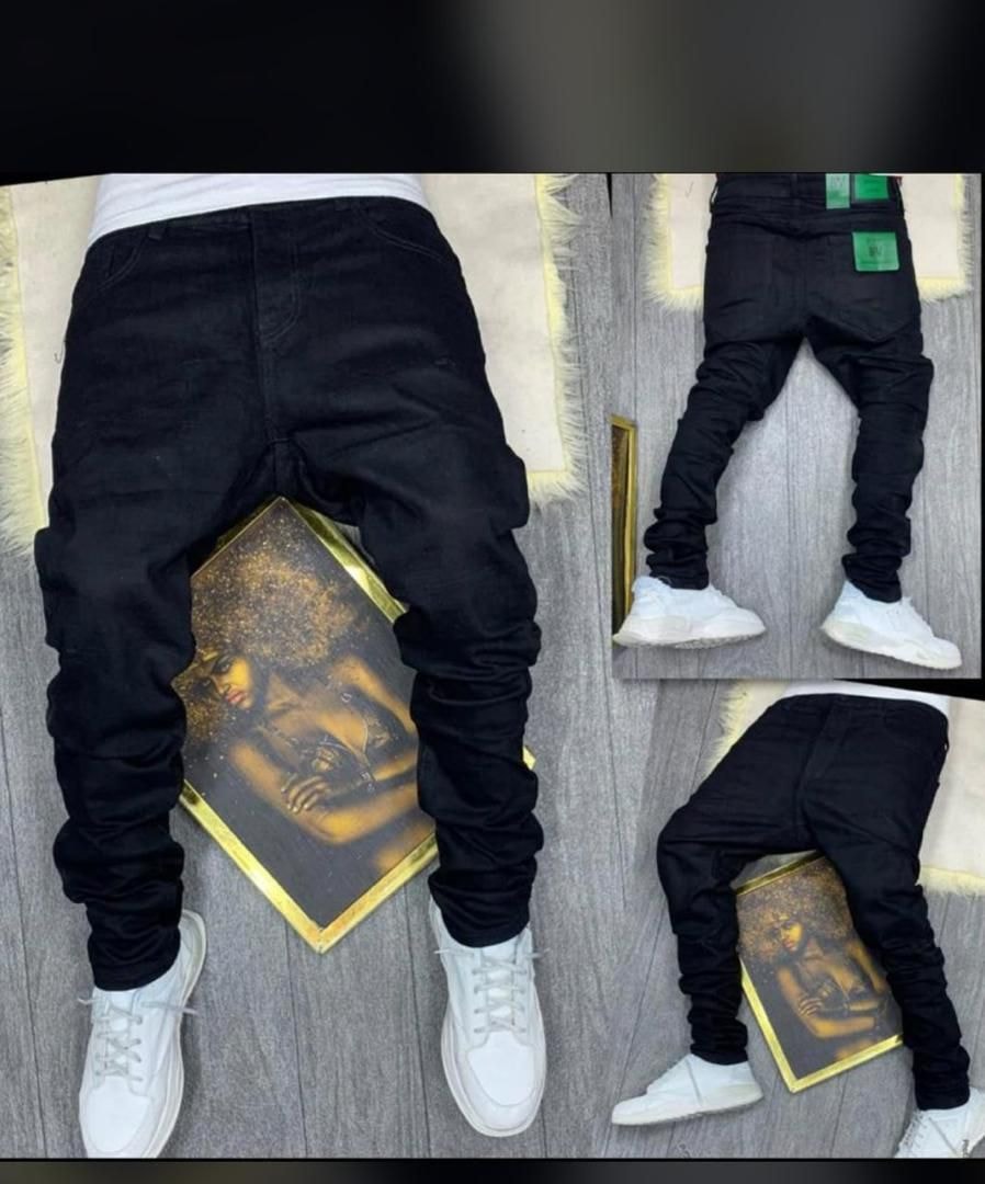 Black jeans modeled from multiple angles including back view paired with white sneakers.