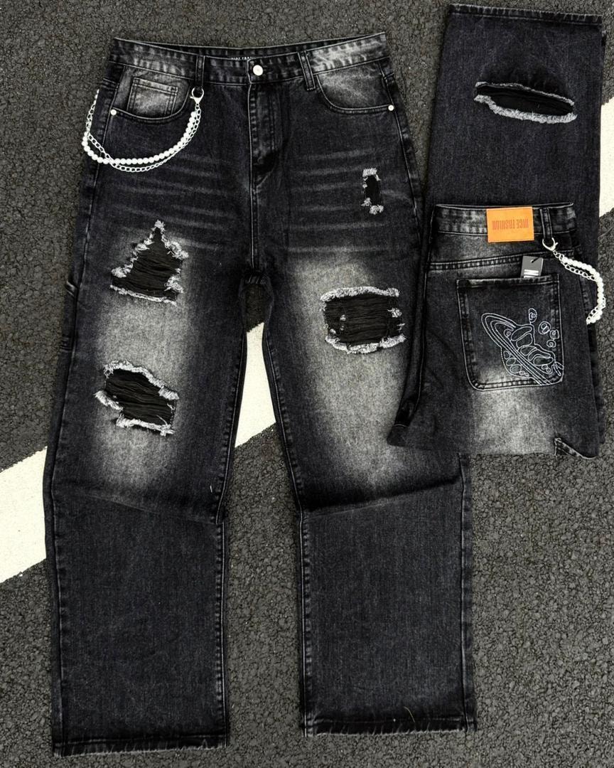 Black ripped baggy jeans with large tears, pearl chain accessory and pocket embroidery.