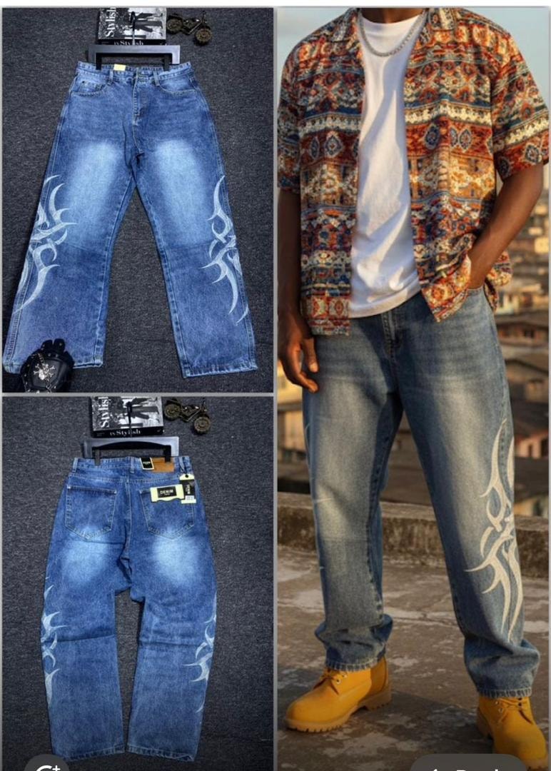 Blue baggy jeans with white flame prints on legs, shown in flat lays and worn with patterned shirt and yellow boots.