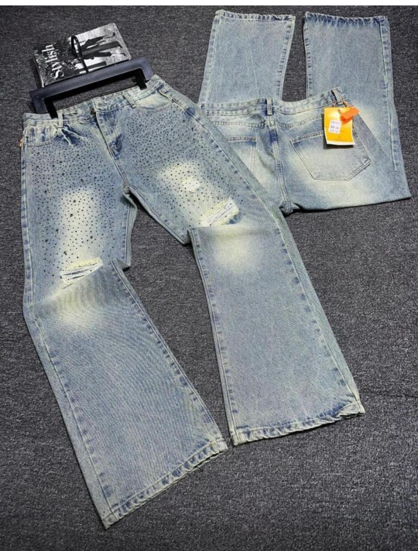 Light blue distressed baggy jeans with perforation details, rips and multiple flat lay views.