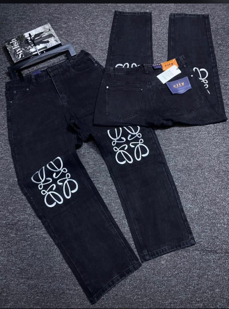 Black baggy jeans with white abstract patterns on legs and back, shown in flat lay.
