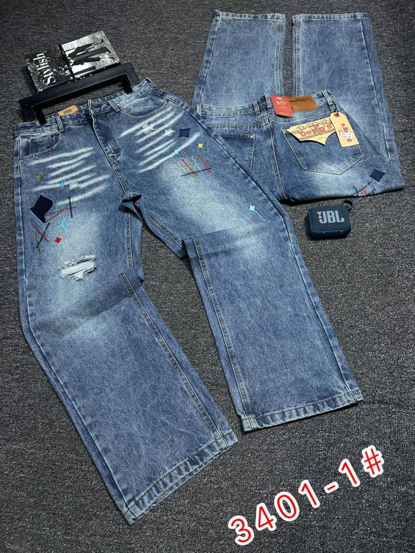 Light blue baggy jeans with rips, colorful patches, and white streaks shown in flat lay with front and back views.