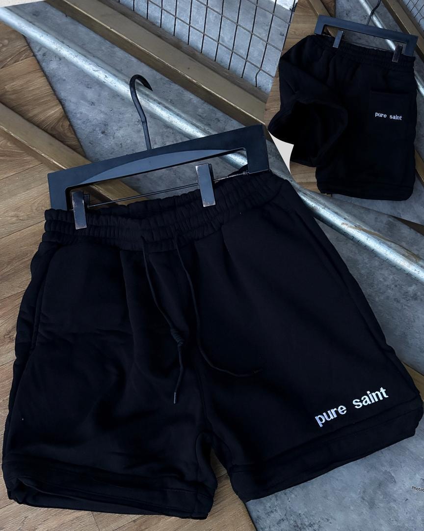 Black unisex fleece shorts with pure saint text on leg and back pocket view.