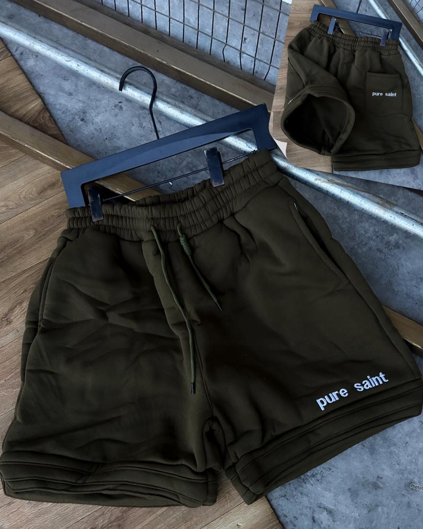 Olive unisex fleece shorts with pure saint text on leg and back pocket view.