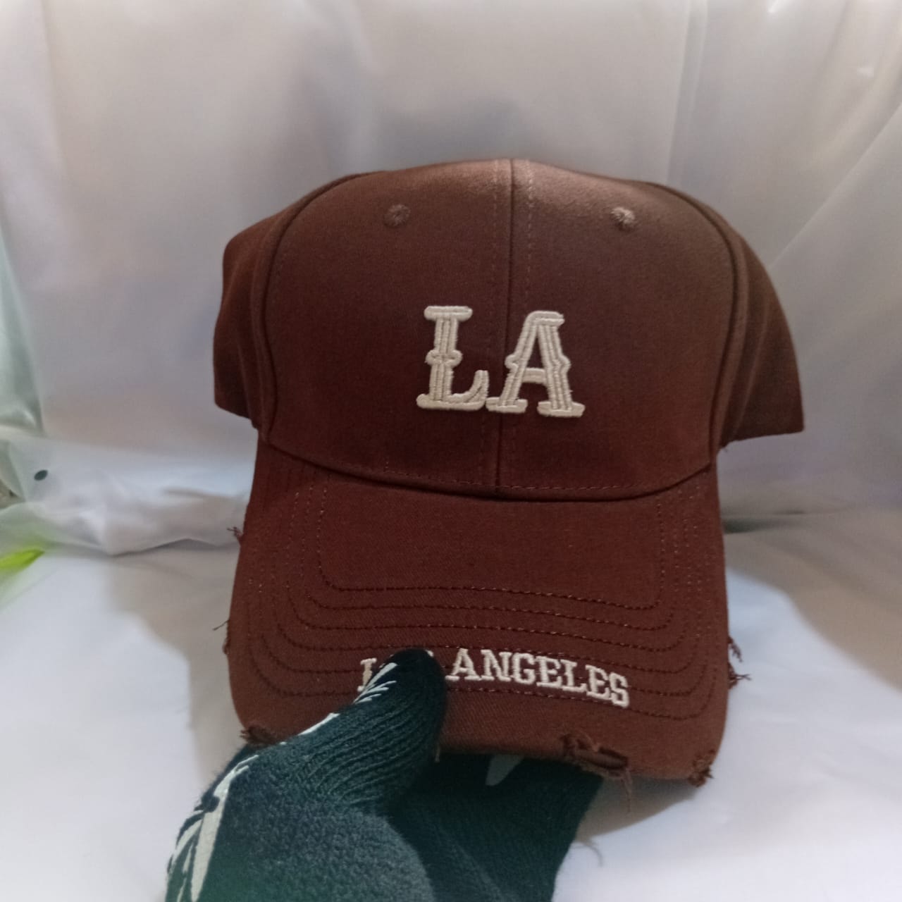 Brown LA Los Angeles embroidered cap with hand adjusting brim.