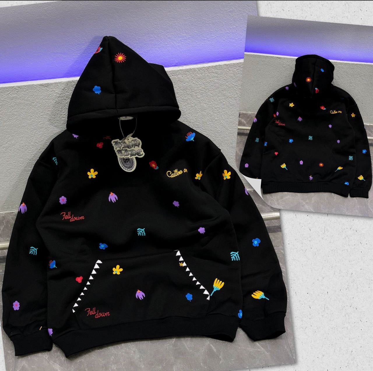 Black oversized hoodie with colorful floral and script embroidery, front and back views.