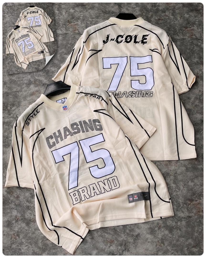 Cream J-Cole Chasing 75 jersey displayed with detailed branding.