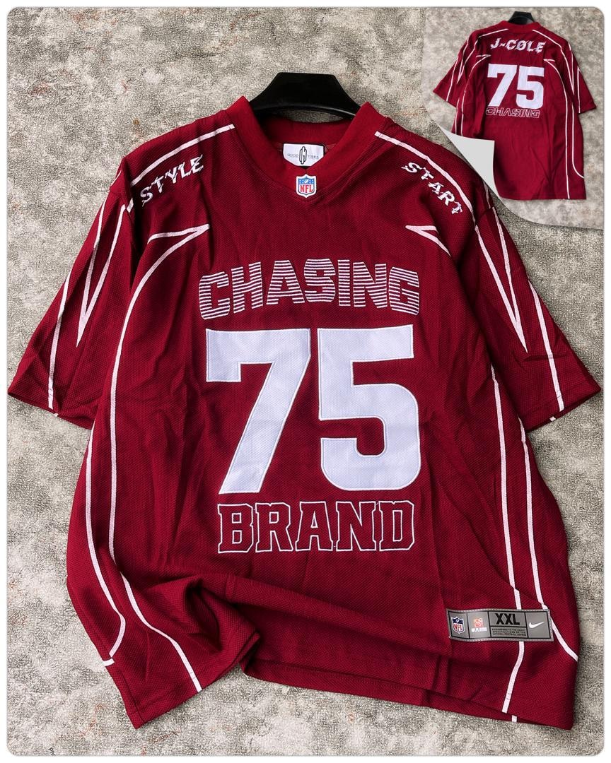 Red J-Cole Chasing 75 jersey on hanger with back view inset.