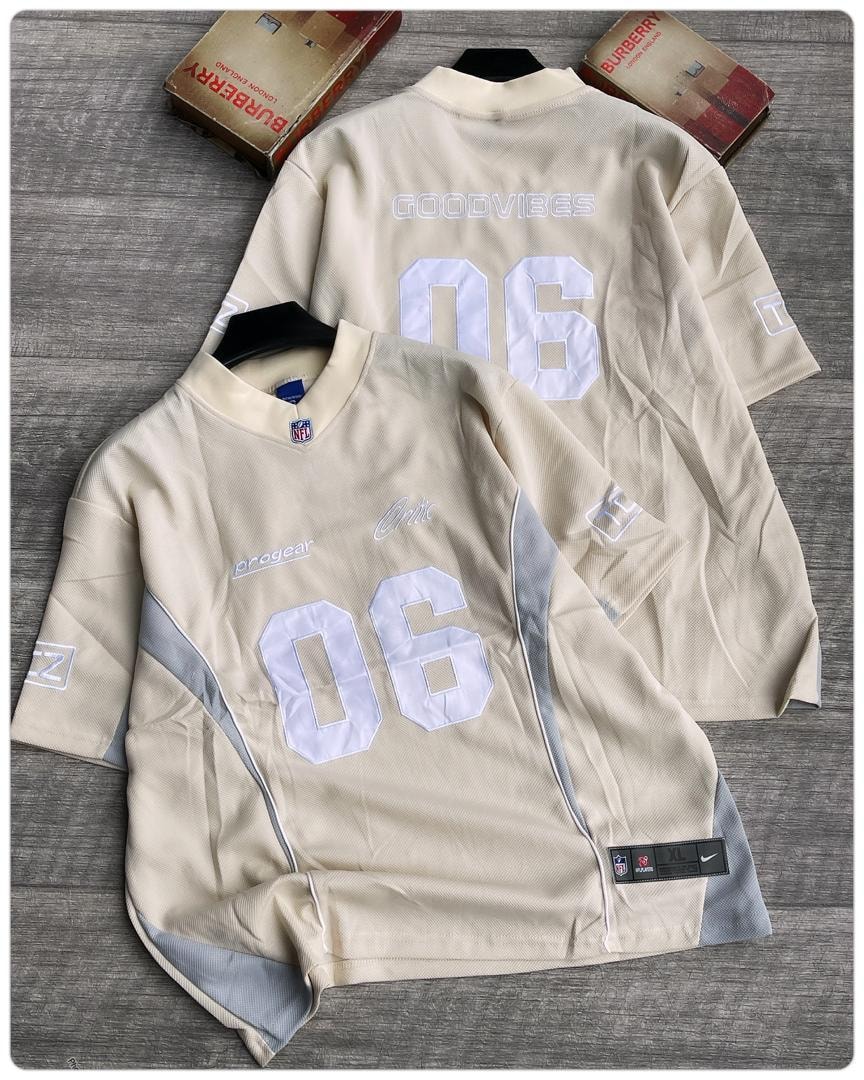 Beige Goodvibes 06 mesh jersey front and back views on wooden surface.