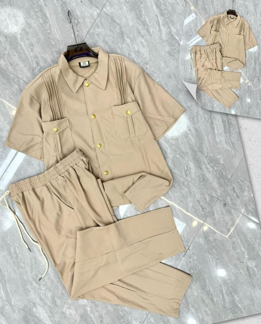 Beige pleated button-up shirt and pants two-piece set with gold buttons.