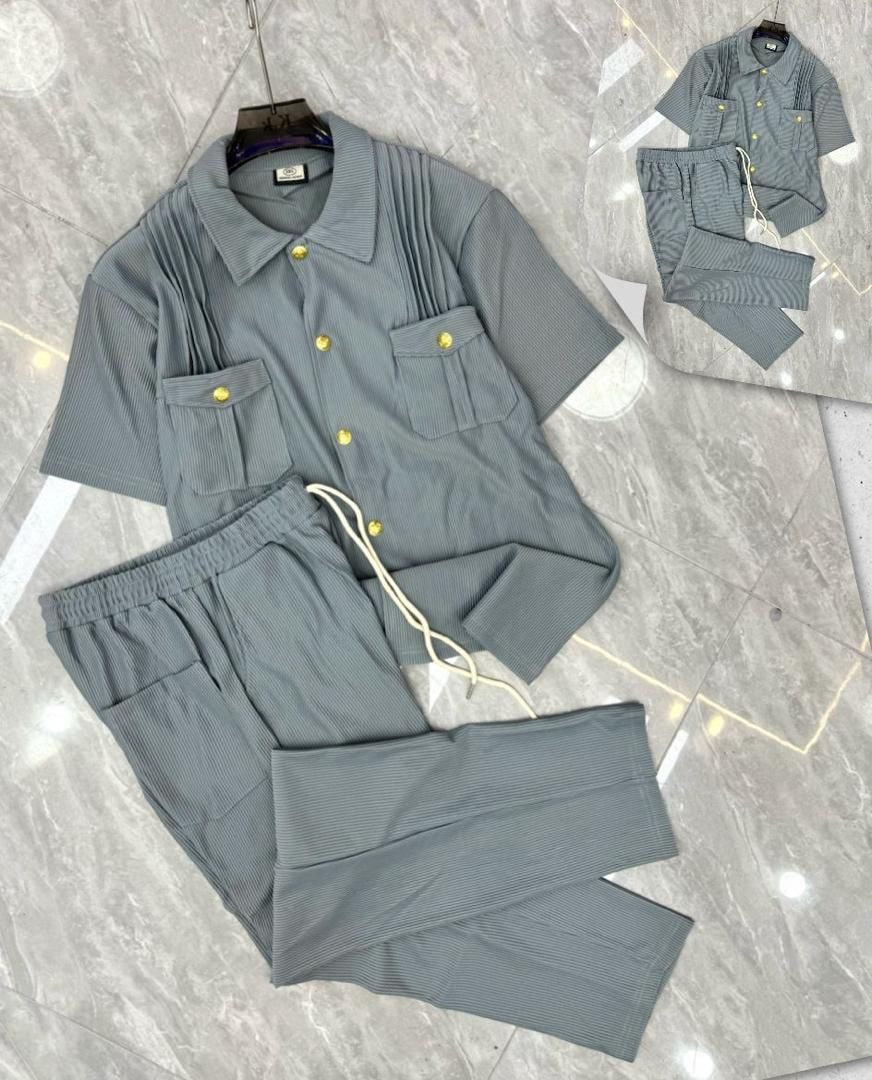 Gray pleated button-up shirt and pants two-piece set with gold buttons.
